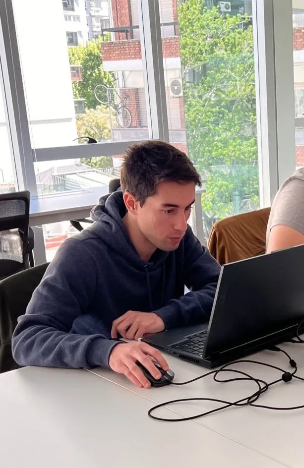 Valentin Boubee, freelance graphic designer, working at a laptop