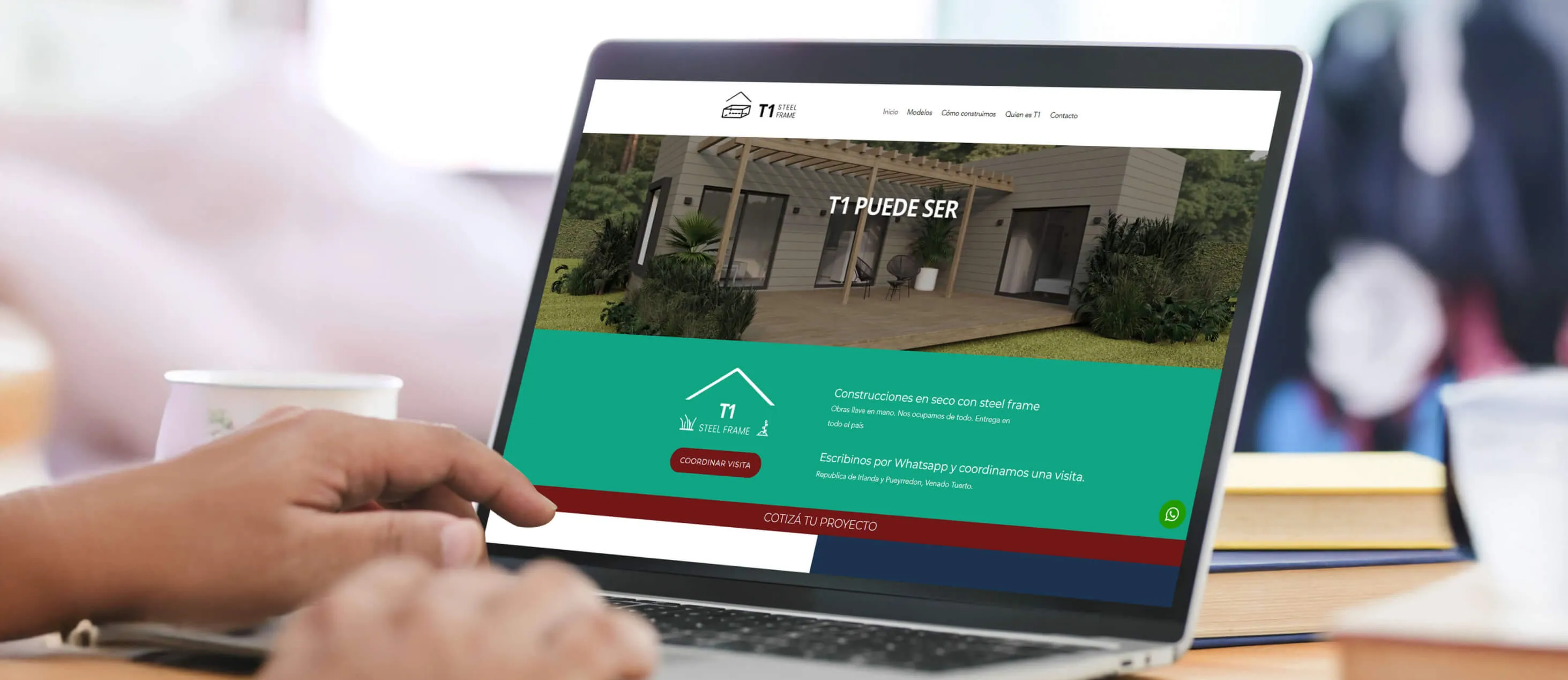 The T1 Steel Frame website shown on a laptop in a workspace